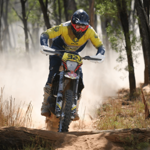 Motocross rider in action on a dirt track in the woods